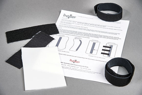 Black velcro straps and thermoplast instructions on a gray surface