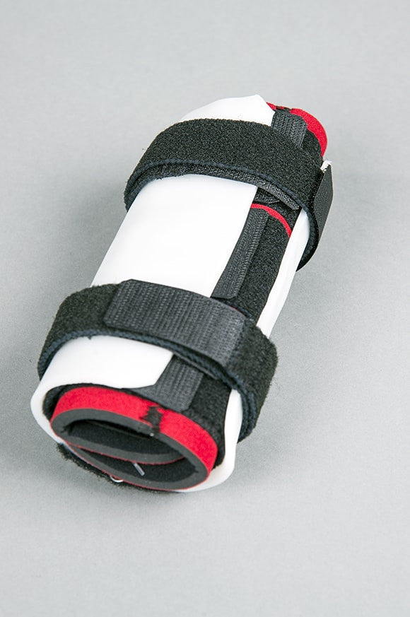 White thermoplast with black and red carpal brace on a gray background