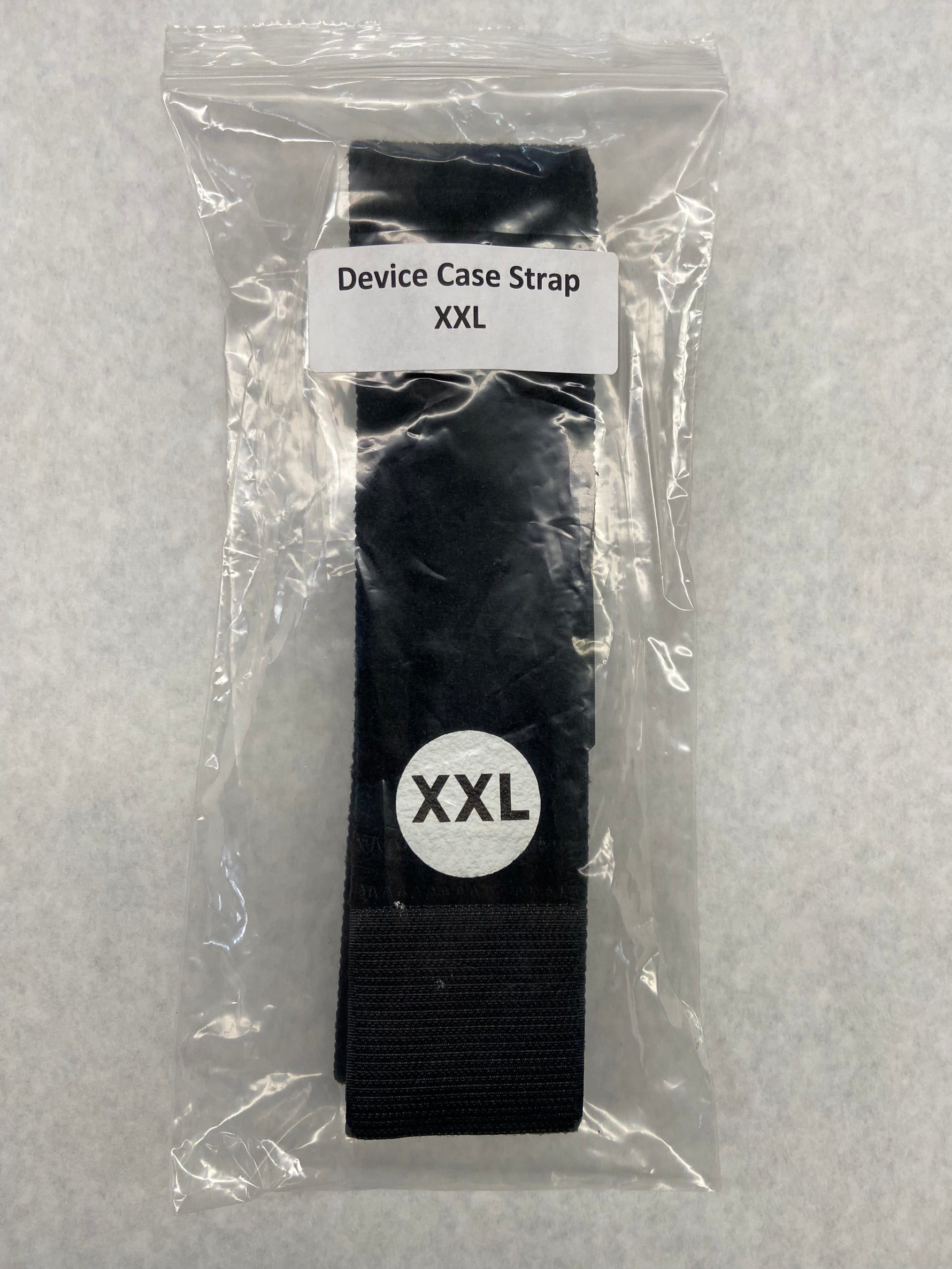 Black device case strap XXL in clear packaging with label on a gray background