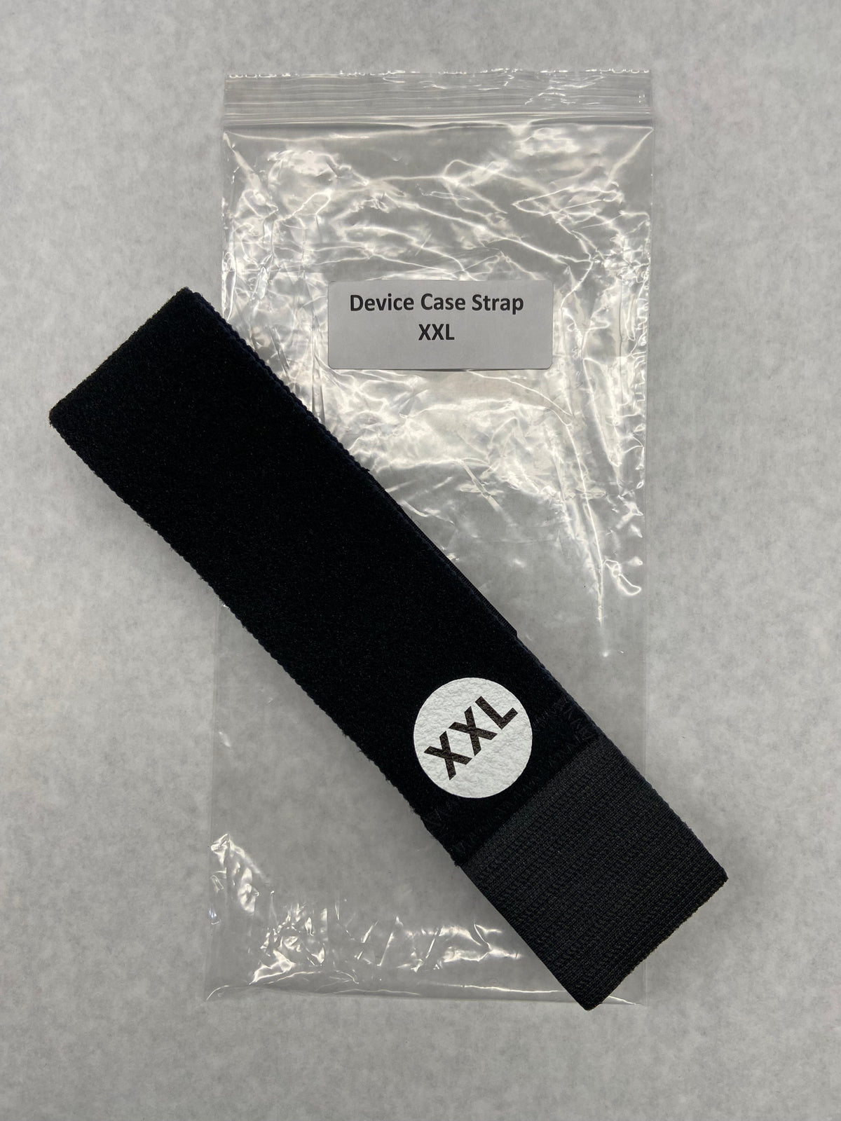Black device case strap with 'XXL' logo on a gray background